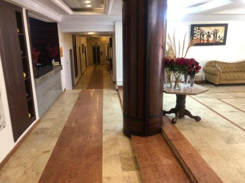 a hallway with a column and a table in a room at Roban Hotels Limited in Enugu