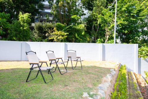 a group of chairs sitting around a table at Beach side spacious 5BR 20pax pool house in Batu Ferringhi