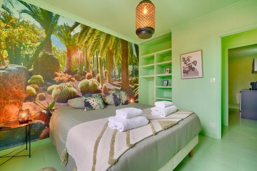 a bedroom with two beds with towels on them at luxury Magic Cactus Garden, Paris 0rly avec jacuzzi in Vigneux-sur-Seine