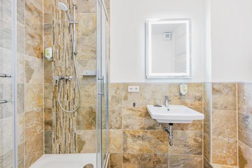 a bathroom with a shower and a sink at Hotel Phoenix in Berghausen