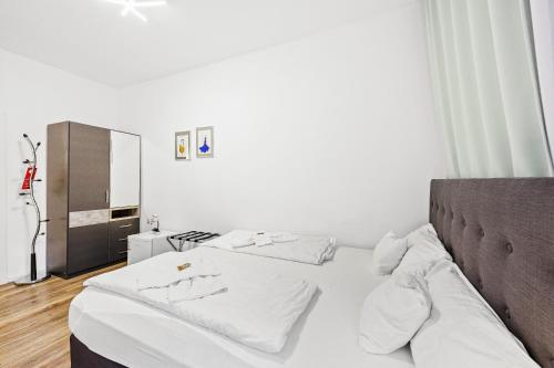 a bedroom with two beds with white sheets at Hotel Phoenix in Berghausen