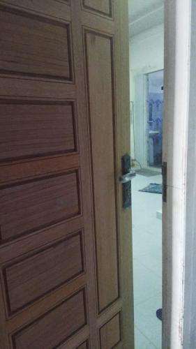 a wooden door in a room with a hallway at Ammaro Homestay and Cafe in Meulaboh