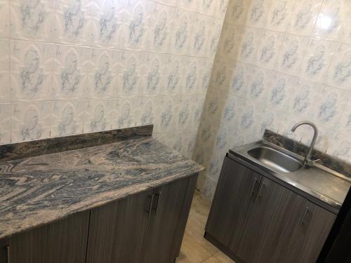 a kitchen with a sink and a counter top at Roban Hotels Limited in Enugu