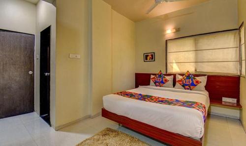 een slaapkamer met een groot bed in een kamer bij FabHotel Sky Vista Inn in Pune