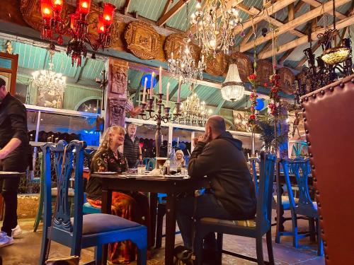 a man and woman sitting at a table in a restaurant at the Lighthouse Beachroom in Cape Town