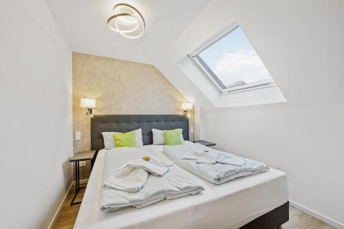 a bedroom with a white bed with a window at Hotel Phoenix in Berghausen