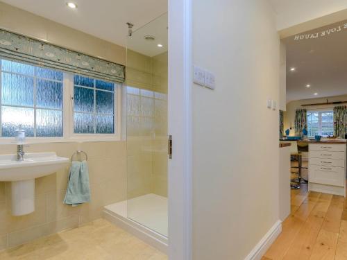 a bathroom with a shower and a sink at 1 Bed in Whatton 77805 in Bingham