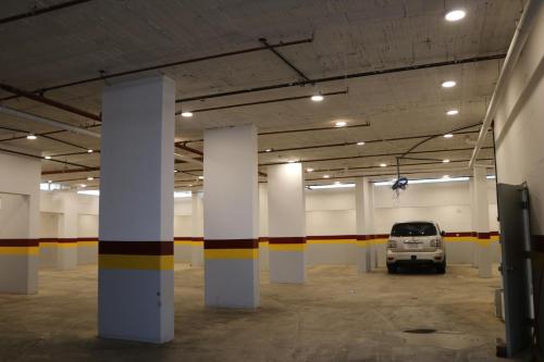 a car parked in a parking lot with columns at قمم بارك 3 Qimam Park Hotel in Abha