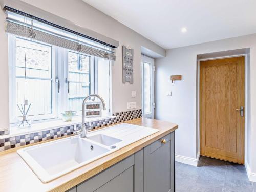 a kitchen with a sink and a window at 2 Bed in Fritchley 81478 in Crich