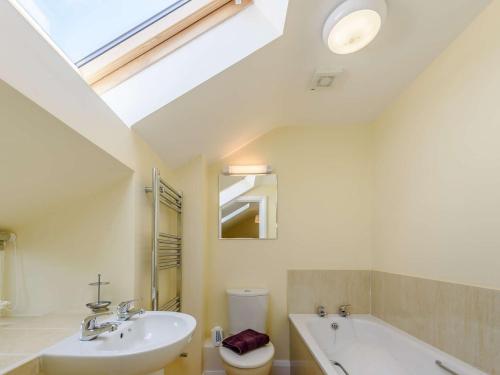 a bathroom with a sink and a bath tub and a skylight at 1 bed property in Bala North Wales 83765 in Llandderfel