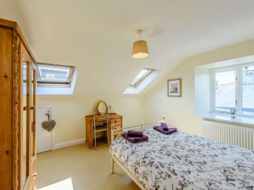 a bedroom with a bed and a desk and windows at 1 bed property in Bala North Wales 83765 in Llandderfel
