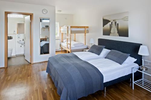 a bedroom with a bed and a bunk bed at South Central Apartments in Brautarholt