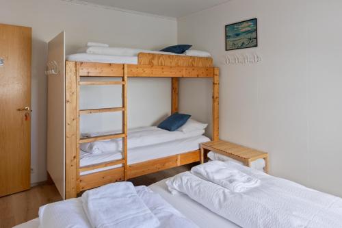 two bunk beds in a room with two beds at South Central Guesthouse in Selfoss