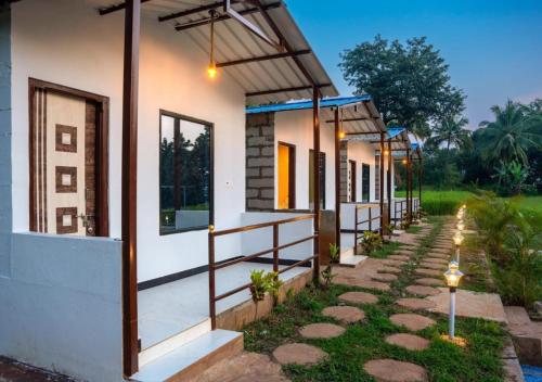 a house with a pathway leading up to it at Areca Jungle Stays by StayApart in Potolai