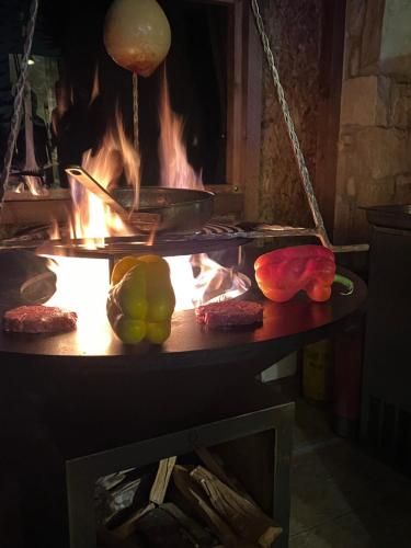 a table with a pot on a stove with fire at Casa del Pastore Rosello in Rosello