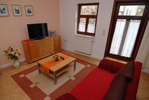 a living room with a couch and a coffee table at Urlaub-in-Stolberg-FeWo-EG in Stolberg i. Harz