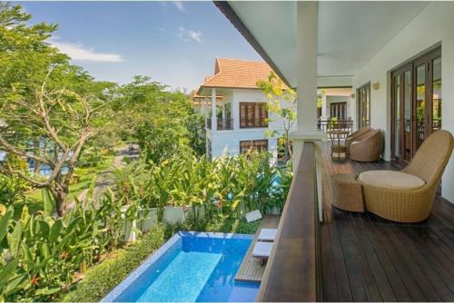 a balcony of a house with a swimming pool at Danang Pool Villas Resort & Spa My Khe Beach in Danang