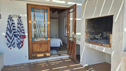 a room with a door leading to a bedroom at Shalom in Paternoster