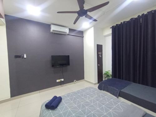 a bedroom with a bed and a ceiling fan at Gr Studio Apartment in Gua Musang