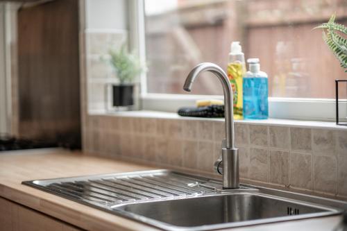 a stainless steel sink in a kitchen with a window at Rochester House in Middlesbrough