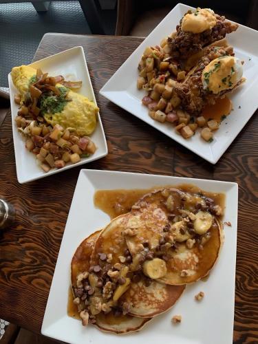 three plates of food on a wooden table at Renaissance Allentown Hotel in Allentown