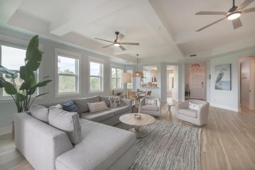a living room with a couch and a table at Ibis At The Sanctuary A302 in Sanibel