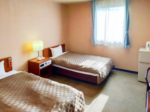 Ένα ή περισσότερα κρεβάτια σε δωμάτιο στο Hotel Kurashiki Mizushima Hills