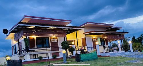 a house with lights on the front of it at Panutsaya Homestay in Wang Nam Khieo