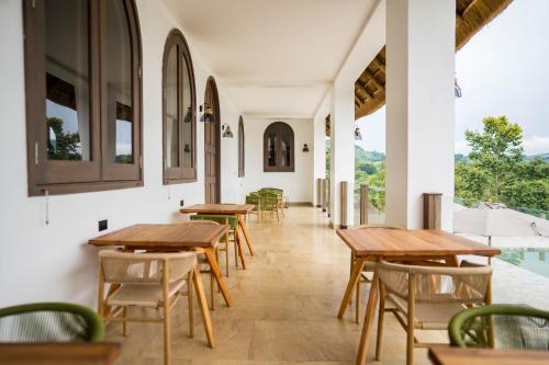 a row of tables and chairs in a restaurant at Tabebuia Spa and Safari Resort in Fort Portal