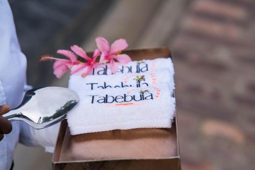 a napkin with the words on it with a spoon at Tabebuia Spa and Safari Resort in Fort Portal