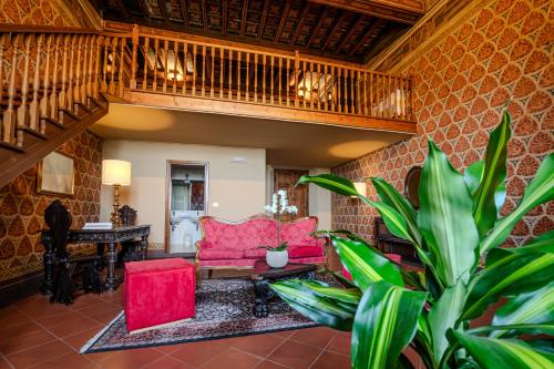 a living room with red furniture and a potted plant at Villa Pitiana in Donnini