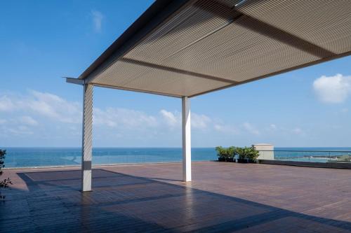 a pavilion with a view of the ocean at Hilton Tel Aviv Hotel in Tel Aviv