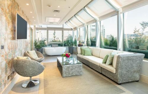 a living room with a couch and a chair at InterContinental Santiago, an IHG Hotel in Santiago