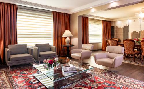 a living room with chairs and a table at InterContinental Santiago by IHG in Santiago