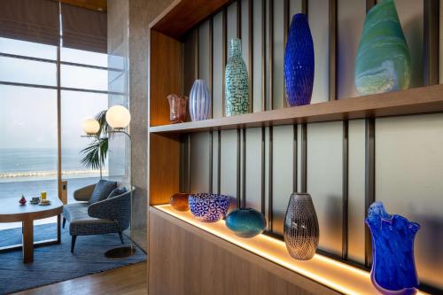 a bunch of vases are on a shelf at Hilton Tel Aviv Hotel in Tel Aviv