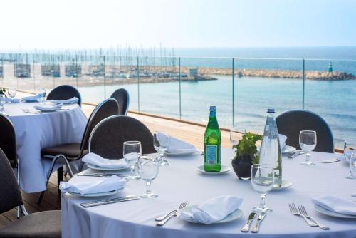 a table with glasses and bottles of wine on it at Hilton Tel Aviv Hotel in Tel Aviv