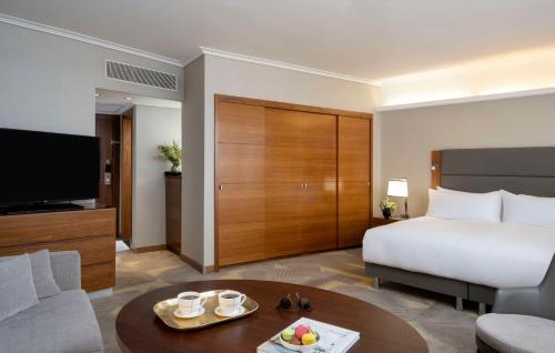 a hotel room with a bed and a television at Hilton Tel Aviv Hotel in Tel Aviv