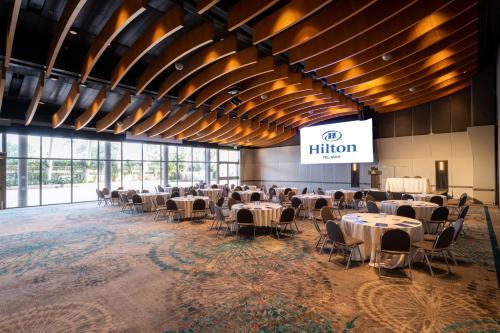 a banquet hall with tables and chairs in a building at Hilton Tel Aviv Hotel in Tel Aviv