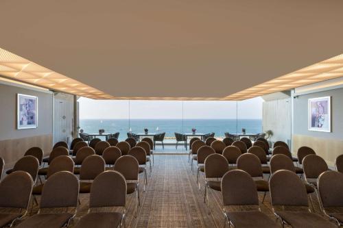 a conference room with chairs and a view of the ocean at Hilton Tel Aviv Hotel in Tel Aviv