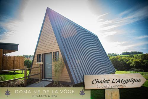 a small building with a sign in front of it at Domaine de la vôge & chalets et spa in Xertigny