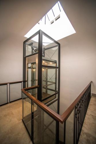 a glass elevator in a building with a skylight at Palazzo del Papa in Siena