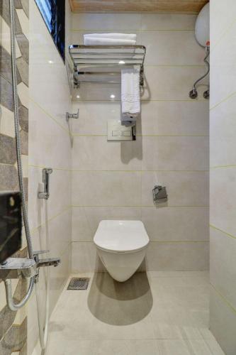a bathroom with a white toilet in a room at Hotel Flysky Rooms & Banquets in Navi Mumbai