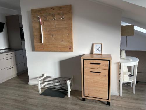 a kitchen with a dresser and a table and a chair at Smart Resorts Haus Azur Ferienwohnung 811 in Winterberg
