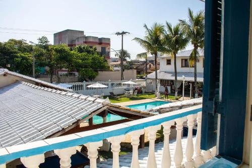 a view of the pool from a balcony of a resort at Pousada da Bia in Rio das Ostras