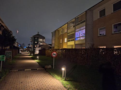 a street at night with street lights next to a building at Apartment Hundige in Greve