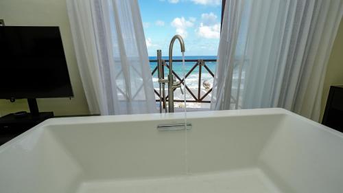 a room with a bed and a view of the ocean at Casa Javi- Ocean Front located Mid Isla Mujeres in Isla Mujeres