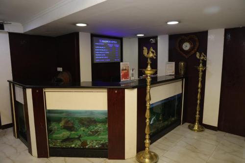 a hotel lobby with a fish tank and a counter at GOLDMINE HOTELS in Chennai