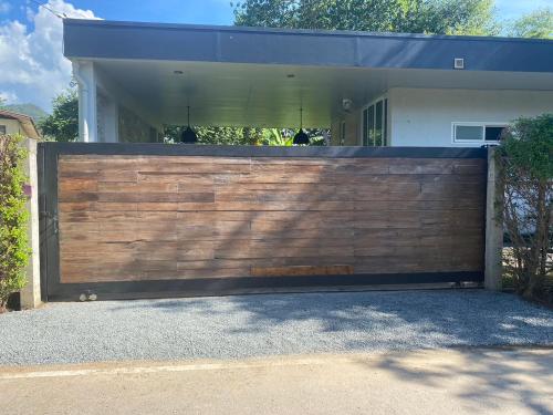 a wooden fence in front of a house at New Chapter House, 3 big bedroom, 1.5 km to centre in Pai