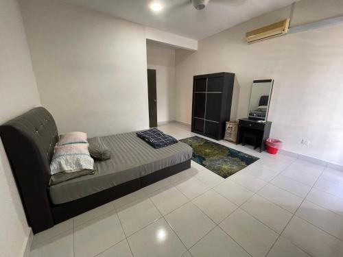 a living room with a couch and a mirror at De’ Nuhir Homestay Teluk Senangin 