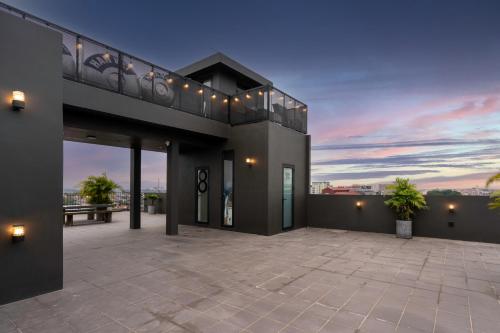a house with a balcony with a sunset at Linn Hotel Bac Giang in Bắc Giang